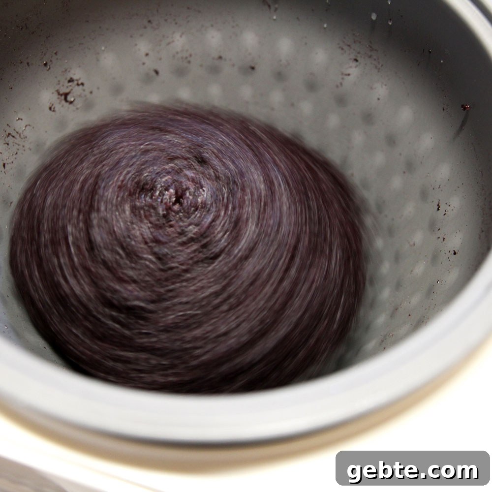 mochi maker will pound the glutinous wild black rice into mochi