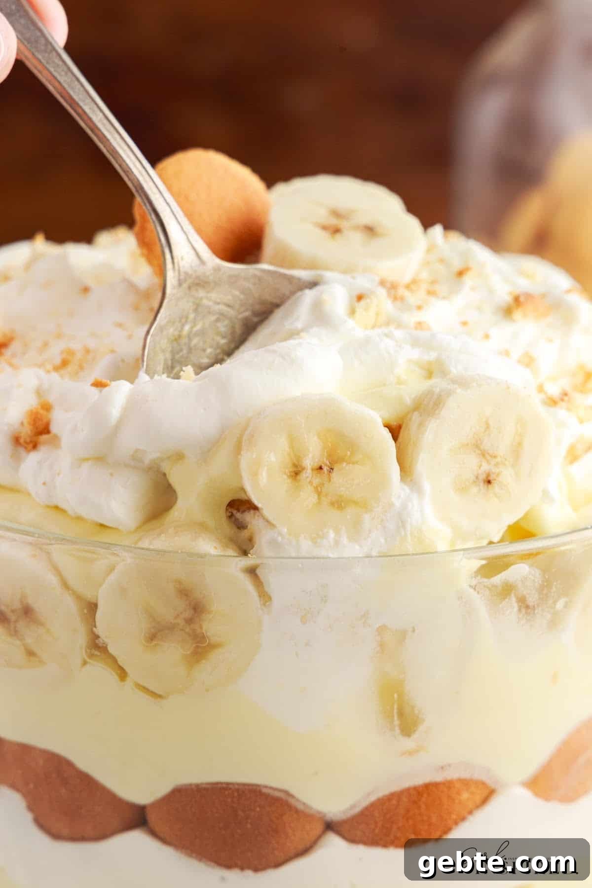 Creamy Banana Pudding Trifle Recipe for Parties and Potlucks 12 Close up of Banana Pudding Trifle with a spoon inserted.