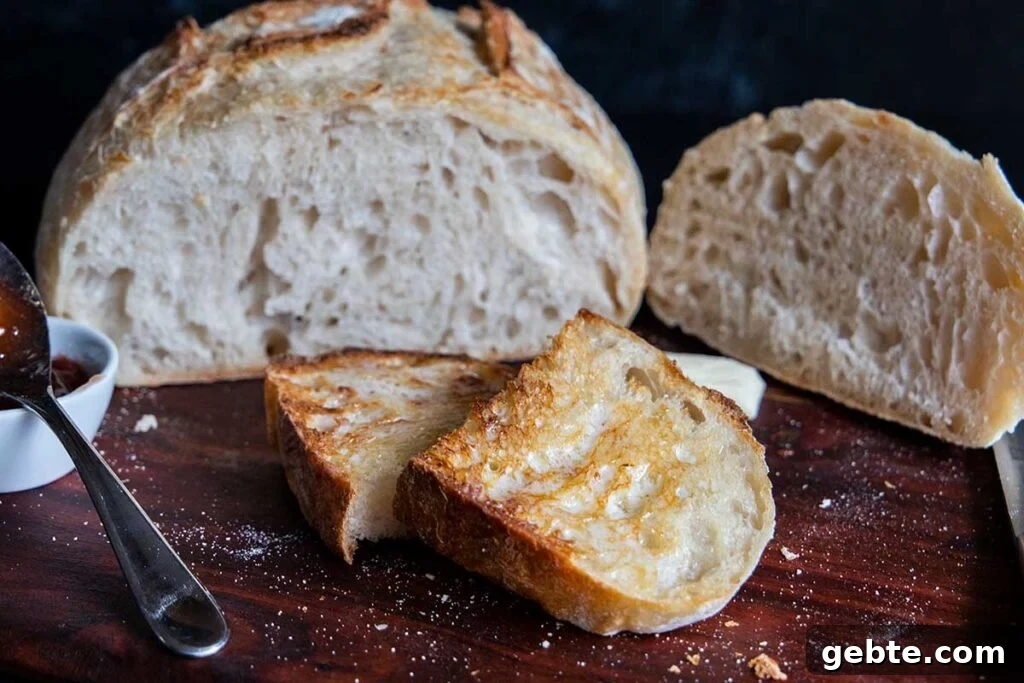 Sourdough bread sliced and toasted on a wooden board.