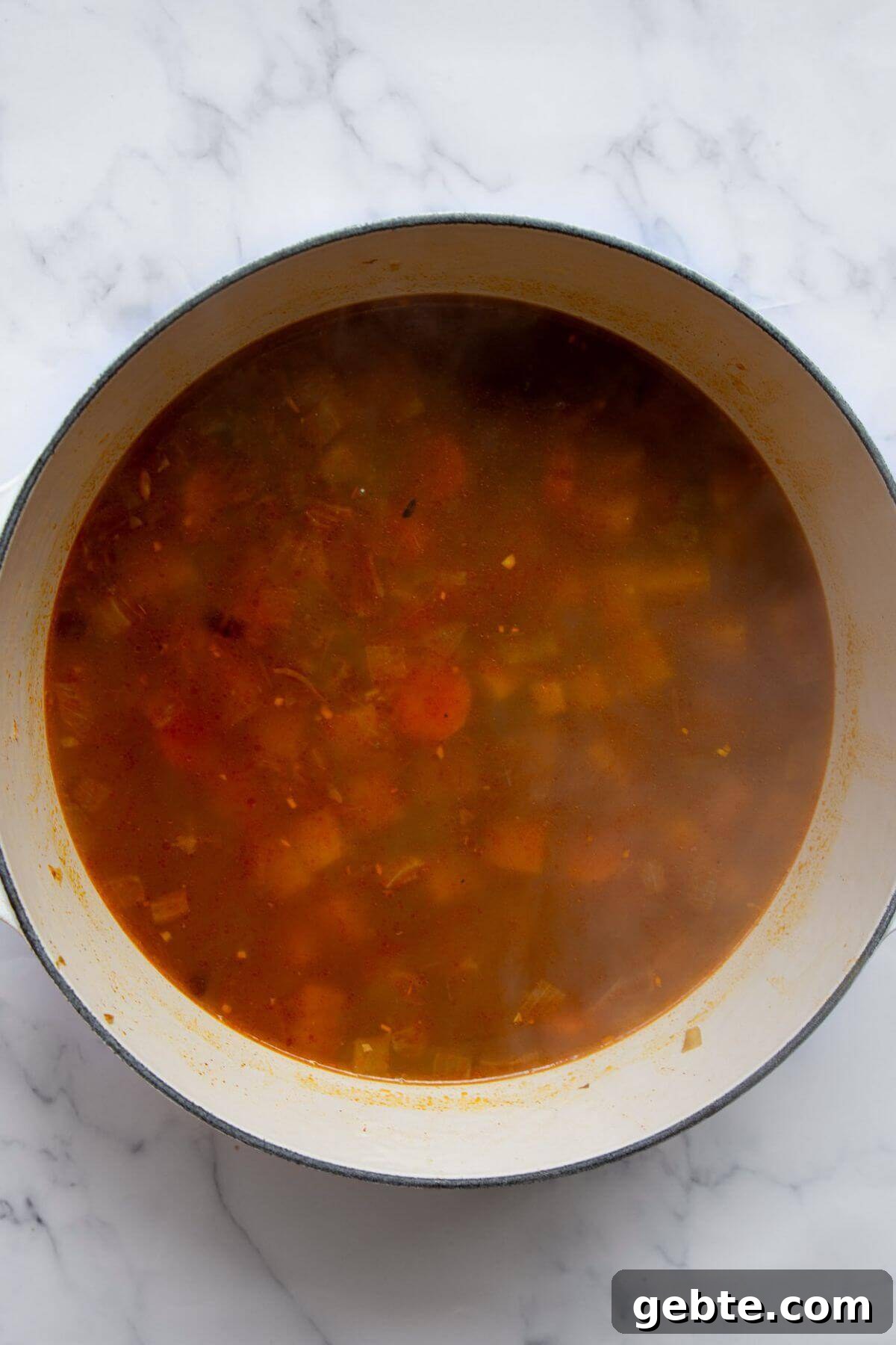Creamy Carrot & Butternut Squash Soup Recipe for Fall Nights 9 Butternut squash and carrot soup simmering in a pot after 20 minutes, with tender vegetables ready to be blended.