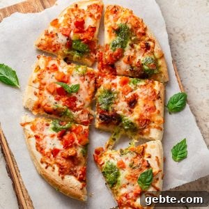 frozen pizza in the air fryer cut into pieces and on a chopping board.