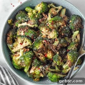 air fryer crispy broccoli in a bowl with chili flakes and parmesan
