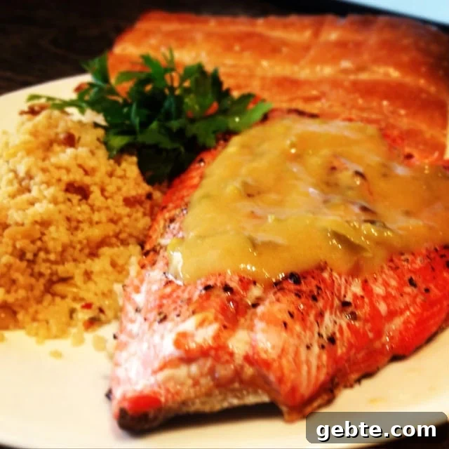 Spicy Peach-Glazed Grilled Salmon Recipe for Summer Meals 2 A close up of a plate of food with a couscous with Peach and Salmon