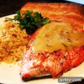 Spicy Peach-Glazed Grilled Salmon Recipe for Summer Meals 9 A close up: plate of couscous and salmon with peach sauce