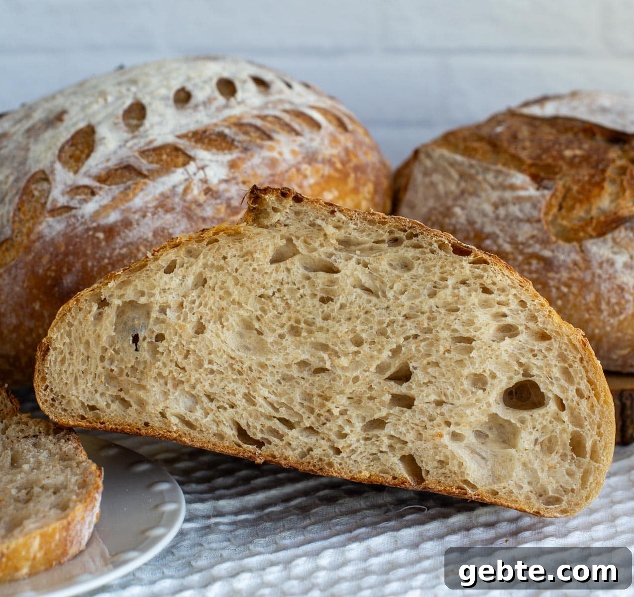 Sourdough Schedule for Beginners: Fit Baking into Your Daily Routine 8 Sourdough bread cut in half with an open crumb.
