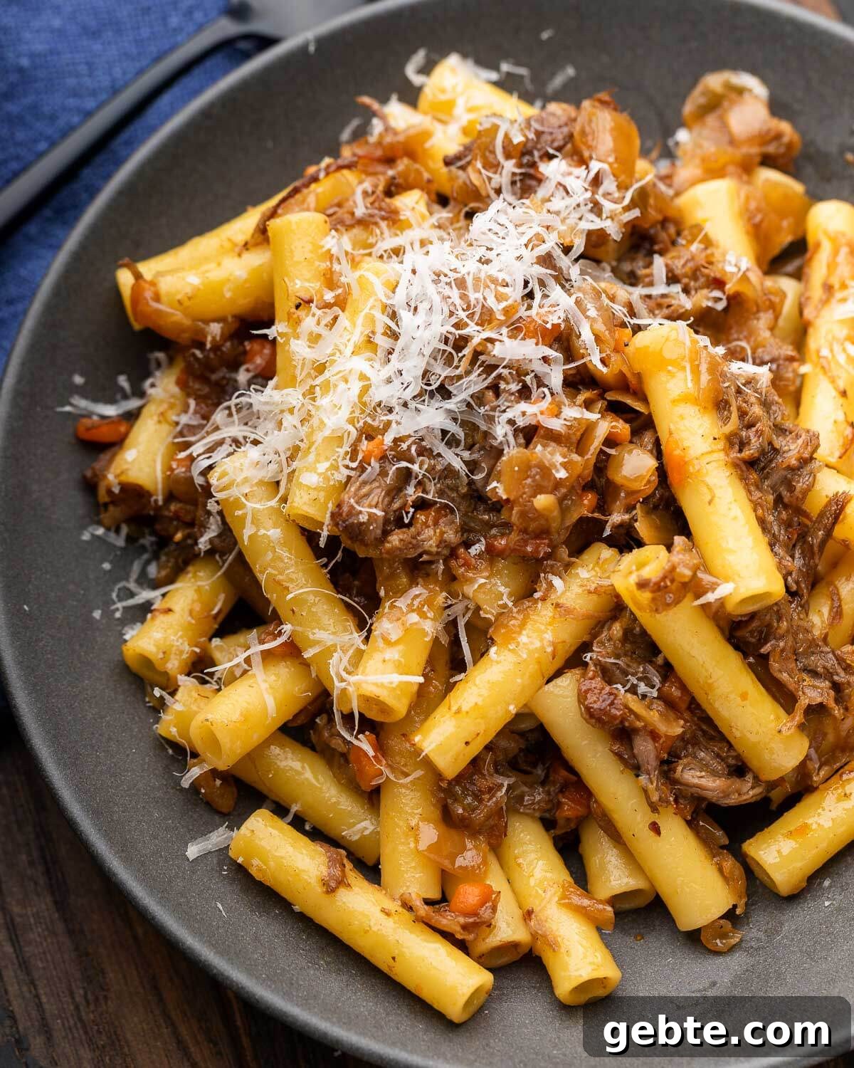 Genovese-Style Pasta with Slow-Cooked Onion Sauce 2 Pasta alla Genovese in grey plate with grated parmesan cheese.