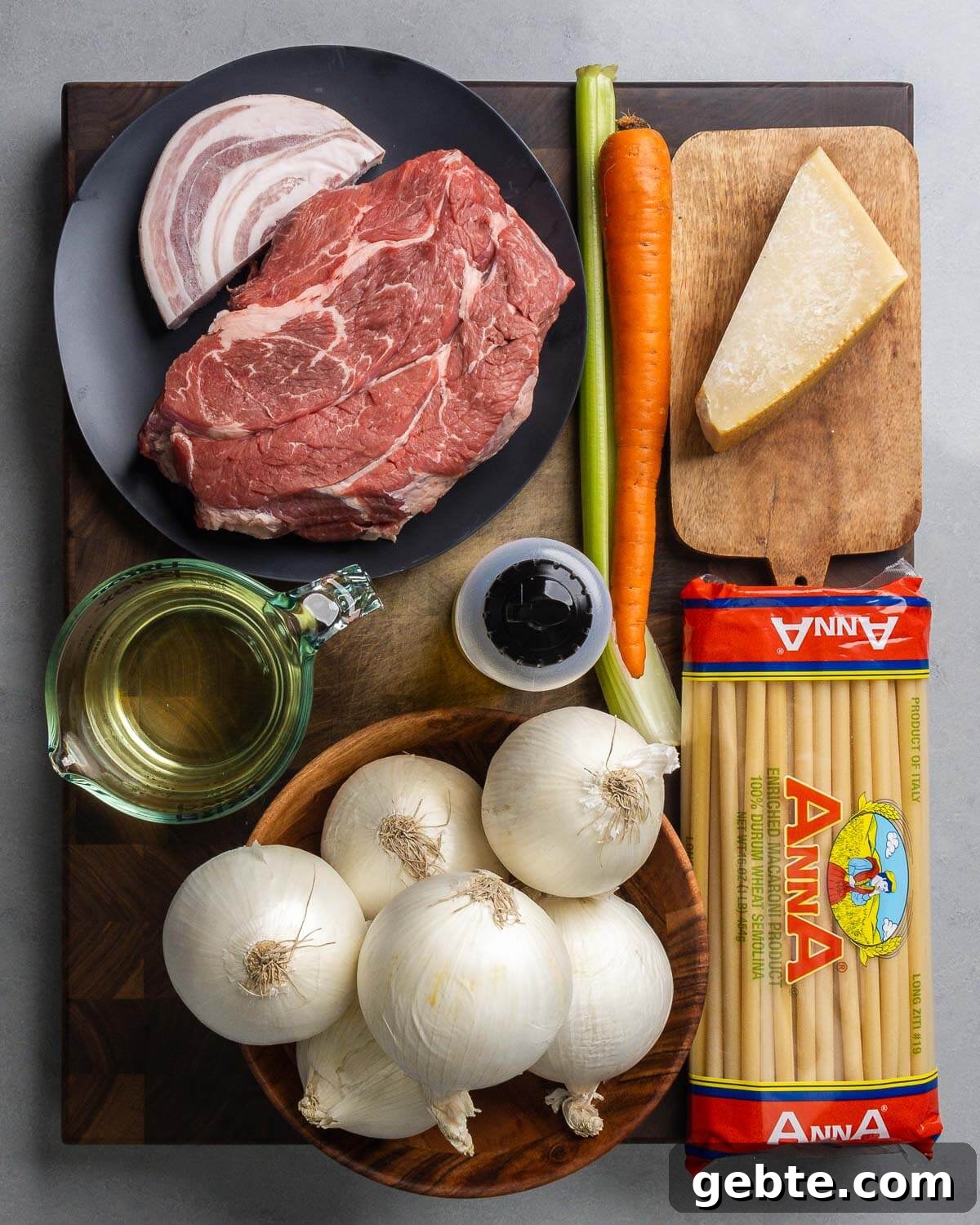 Genovese-Style Pasta with Slow-Cooked Onion Sauce 3 Ingredients shown: pancetta, chuck roast, celery, carrot, Parmigiano Reggiano, white wine, olive oil, onions, and long ziti.