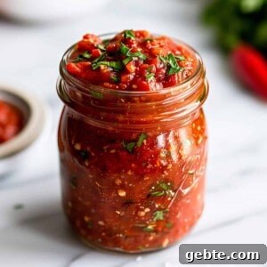Homemade Arrabbiata pasta sauce in a glass jar.
