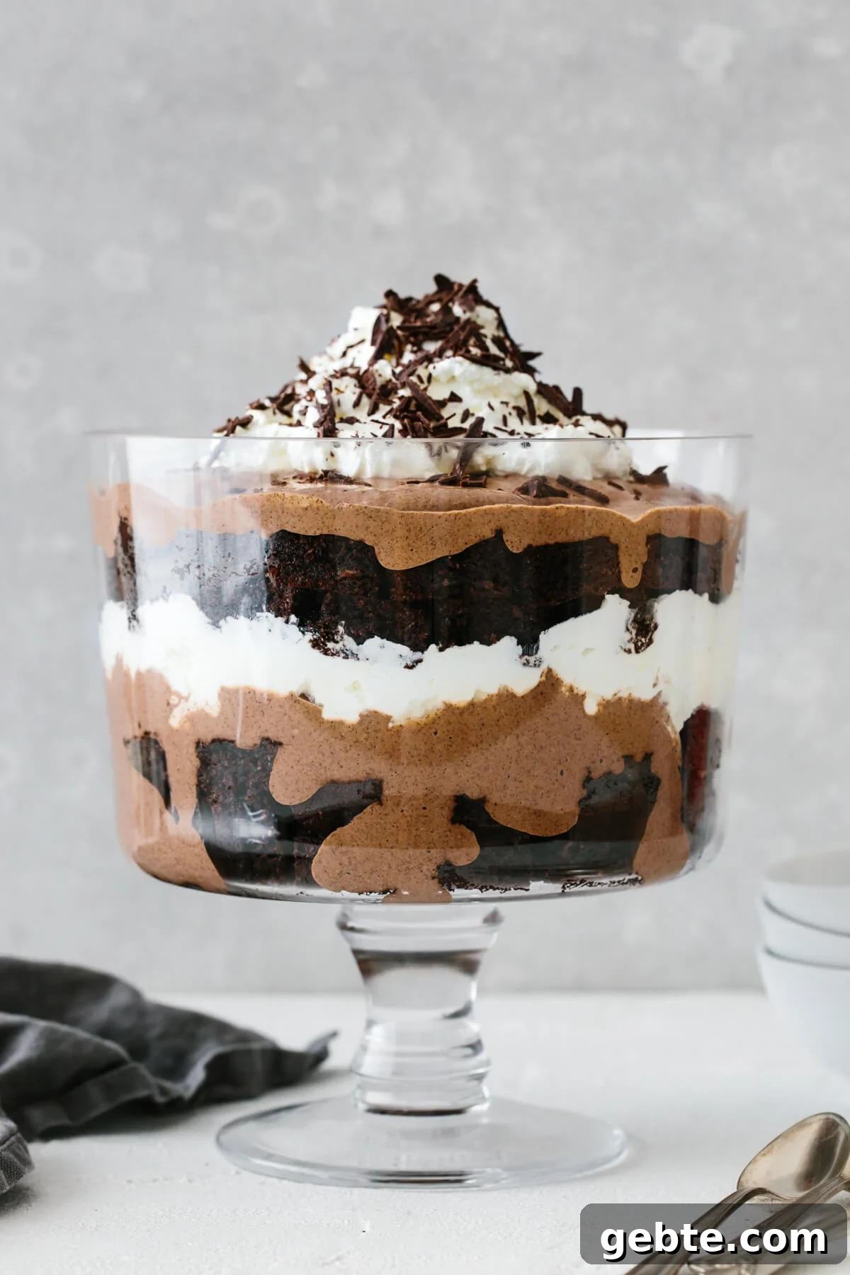 A layered brownie trifle in a trifle bowl.