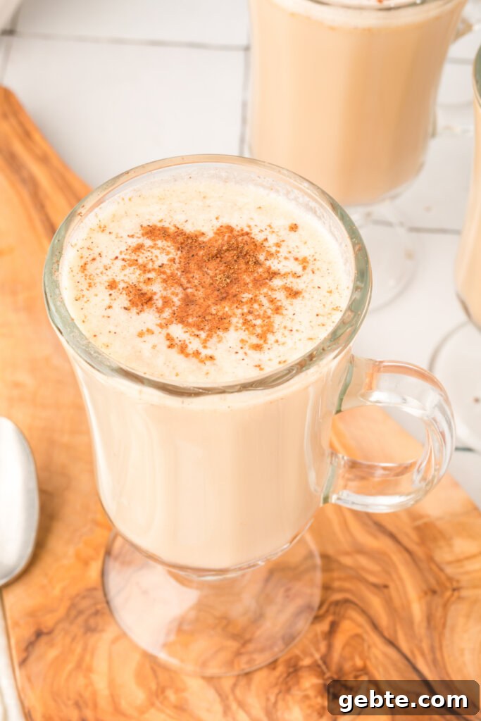How to Make Hot Buttered Rum Mix at Home 3 ground nutmeg sprinkled over the top of a glass with hot buttered rum