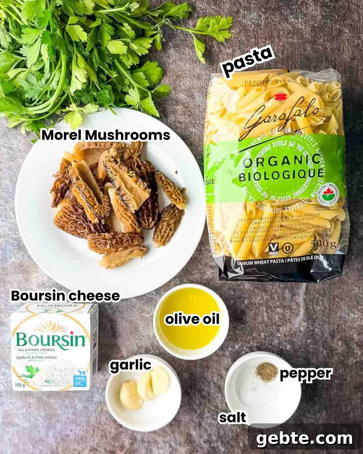 The labeled ingredients for Morel Mushroom Pasta with Boursin Cheese, including fresh morel mushrooms, pasta, garlic, Boursin cheese, olive oil, butter, salt, and pepper.