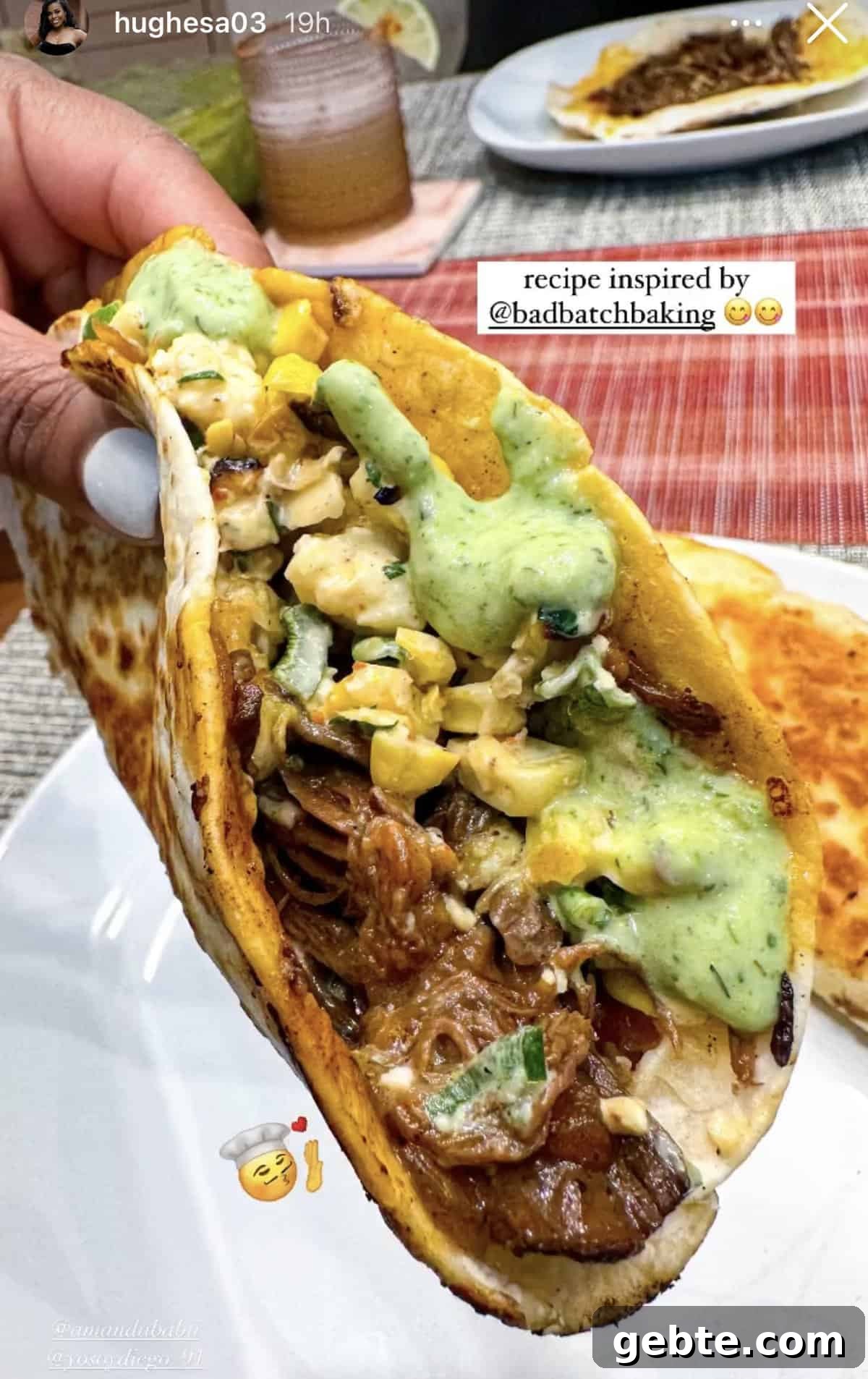 A hand holding a basket taco