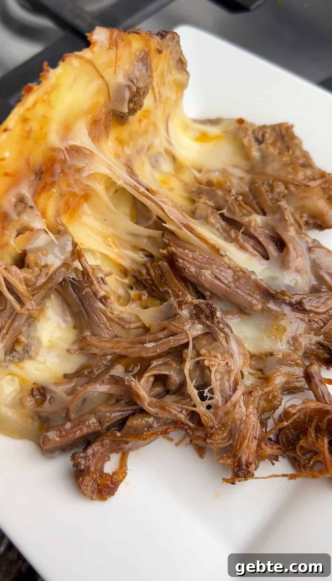 A brisket taco with melted cheese opened to add toppings