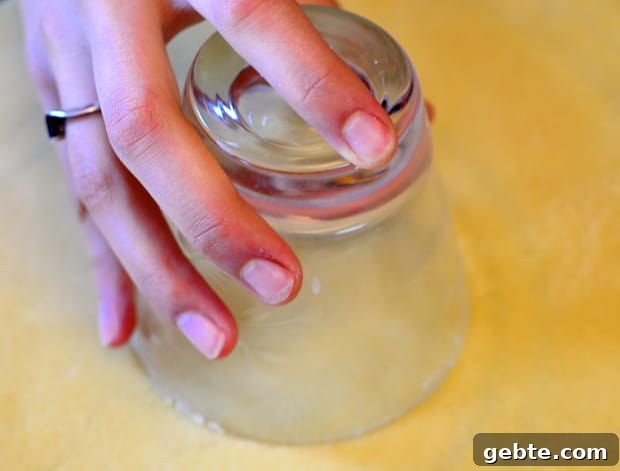 making a circle in the boureka dough with a round glass