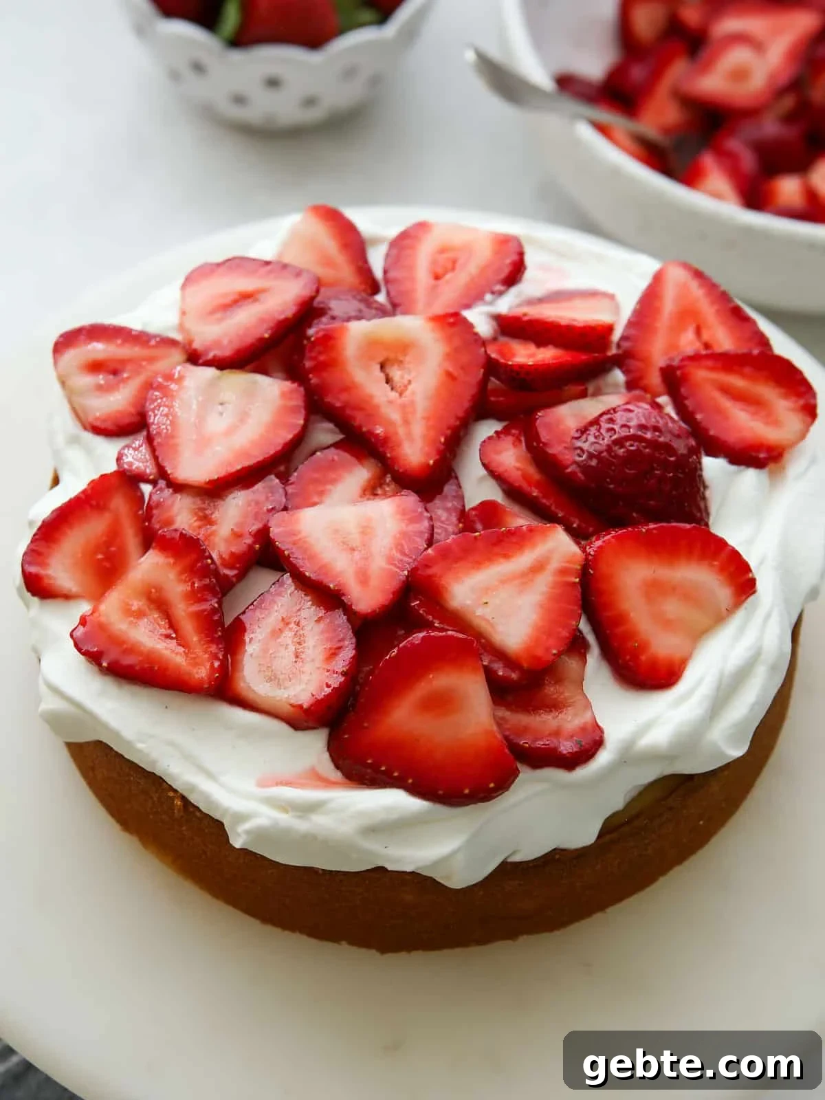 layer of cake, whipped cream and strawberries while assembling cake