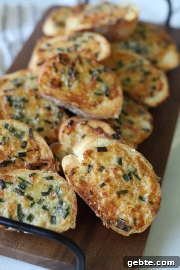 Air fryer garlic toast on wooden serving platter.