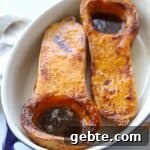halved butternut squash in casserole dish filled with brown sugar butter mixture