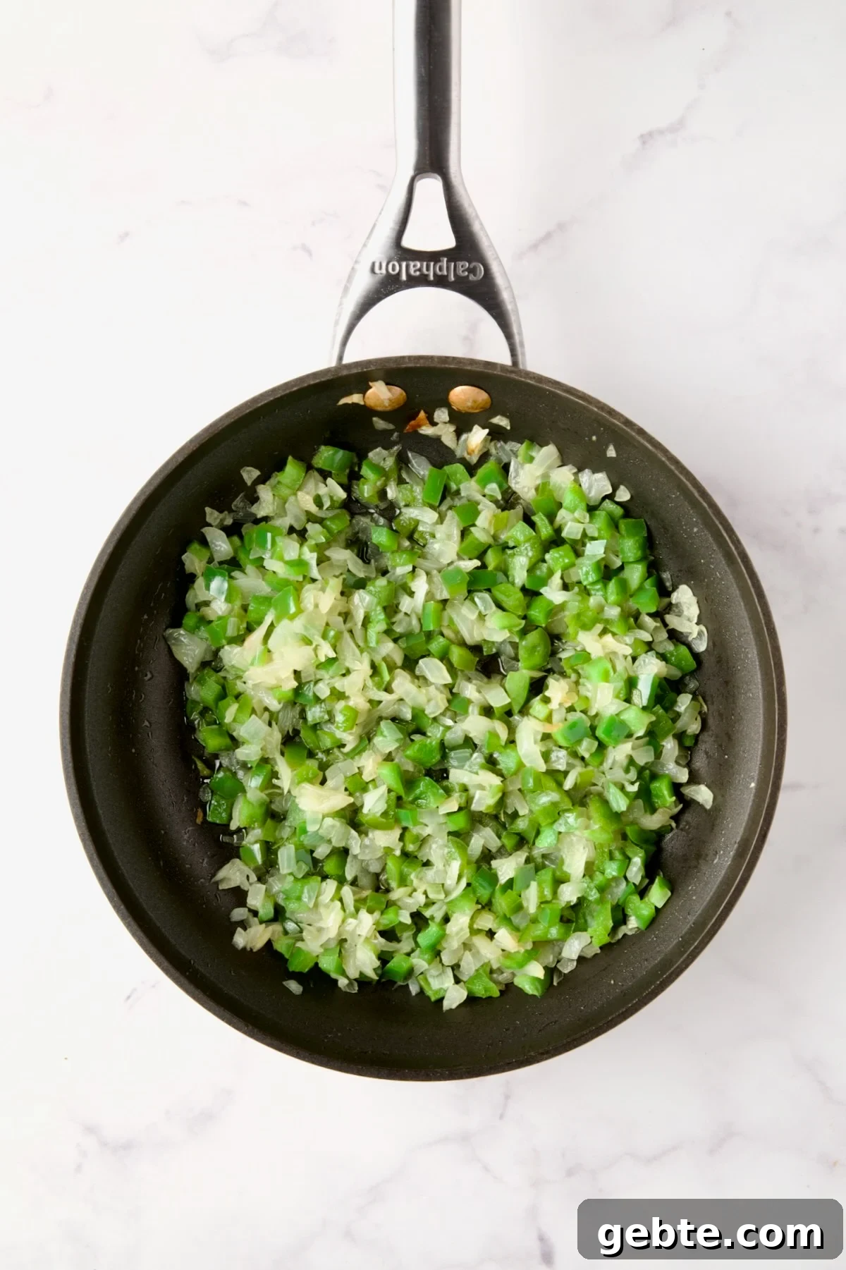 Cooked onions and green peppers in nonstick skillet.