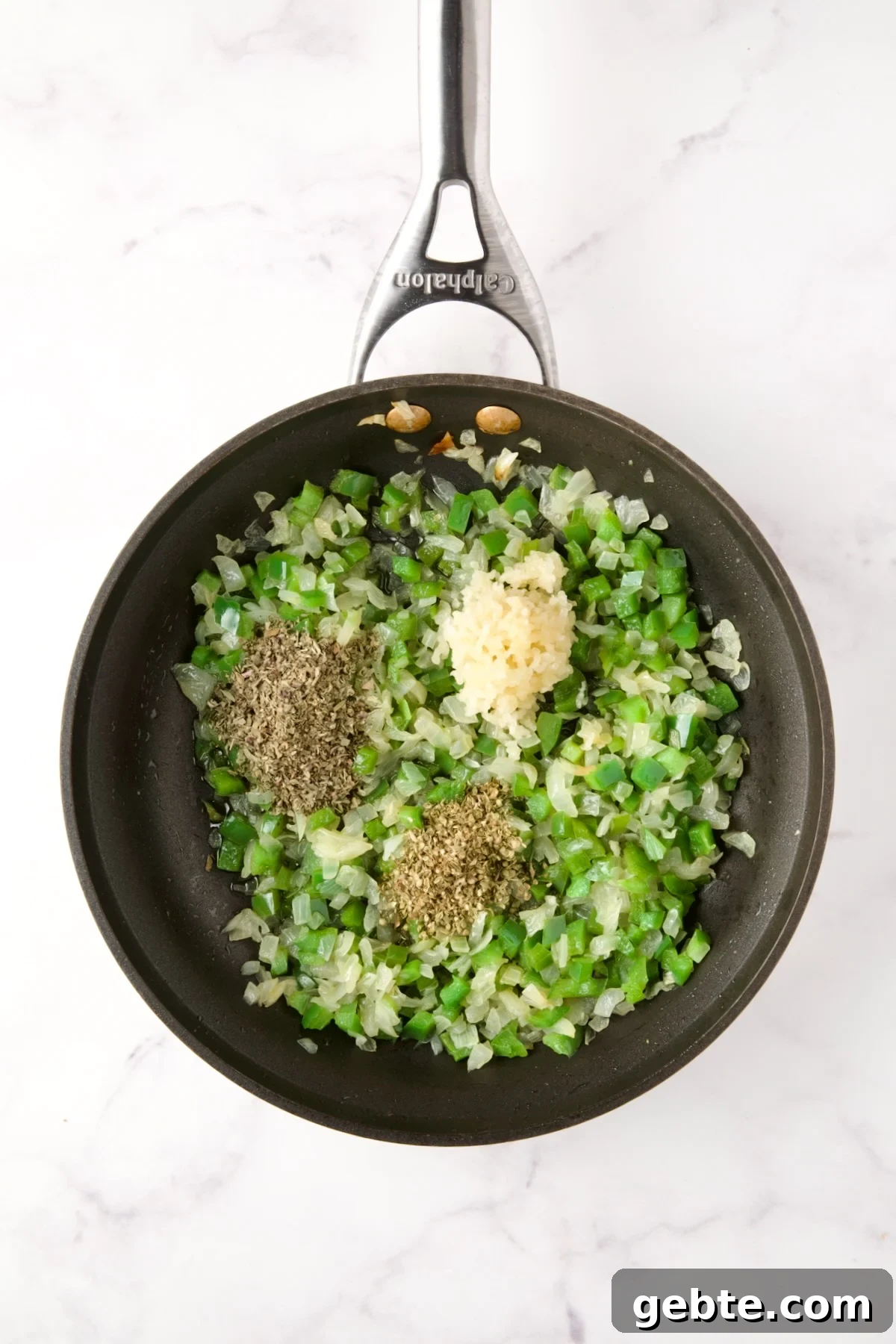Cooked onions and green peppers in nonstick skillet with dried herbs and garlic added.