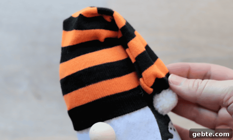 Striped sock on top of gnome.
