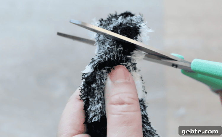 Scissors trimming excess off of gnome hat.