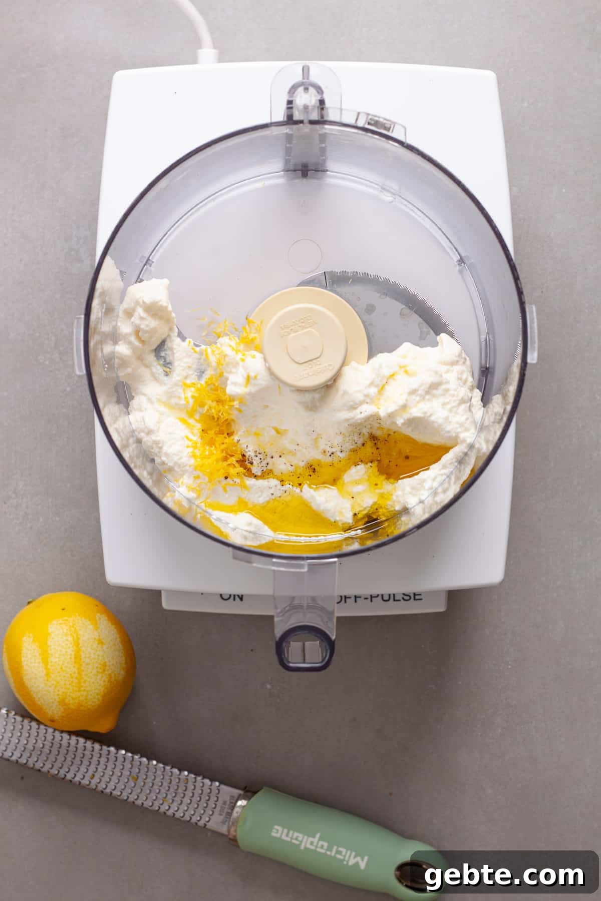 Ricotta cheese, lemon zest, salt, pepper and olive oil in a food processor.