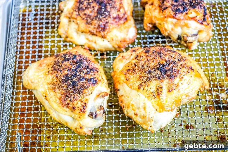 Crispy Air Fryer Chicken Thighs Recipe in 25 Minutes 5 Cooked Chicken Thighs On Air Fyrer Basket