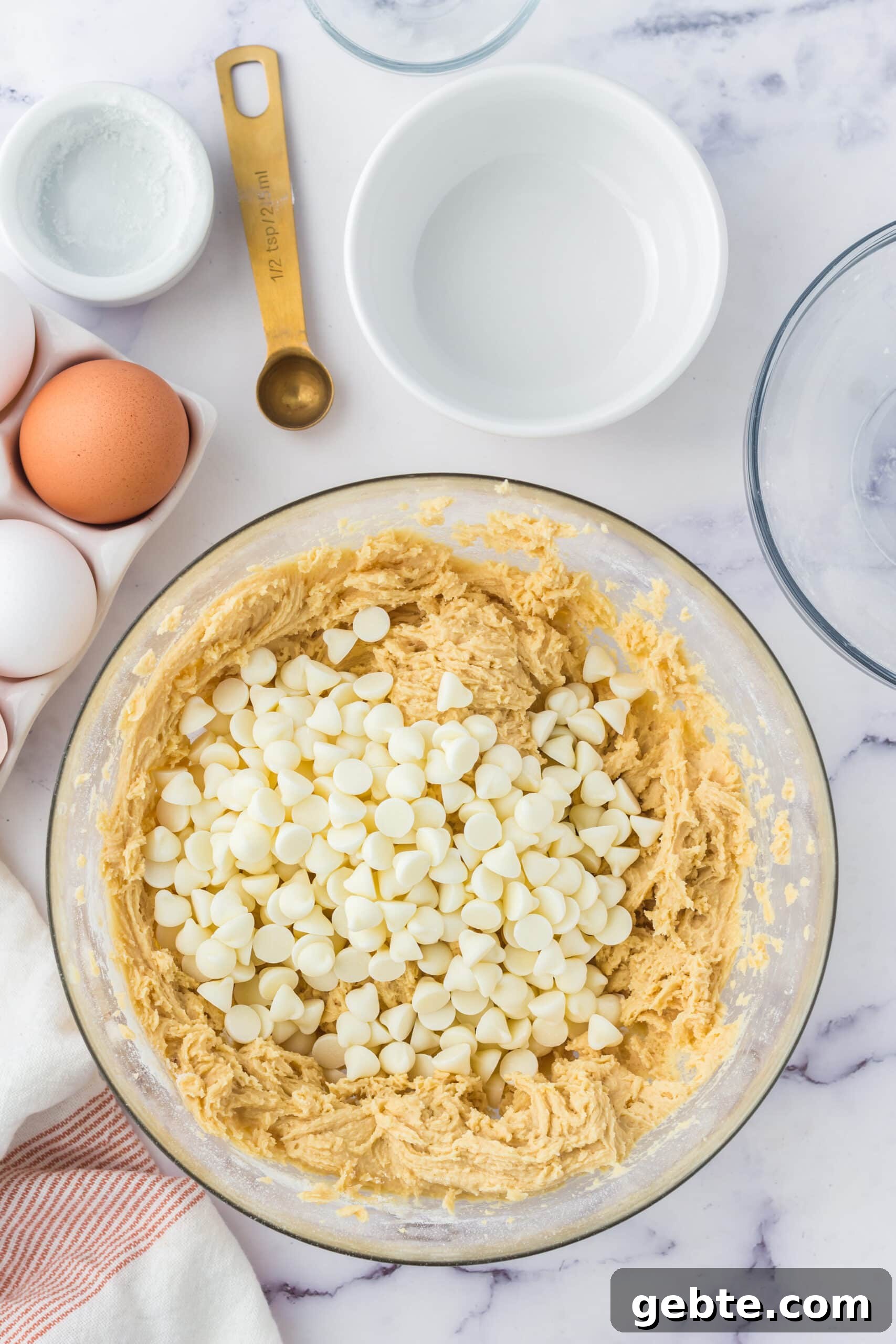 picture of cookie batter and white chocolate chips in a bowl