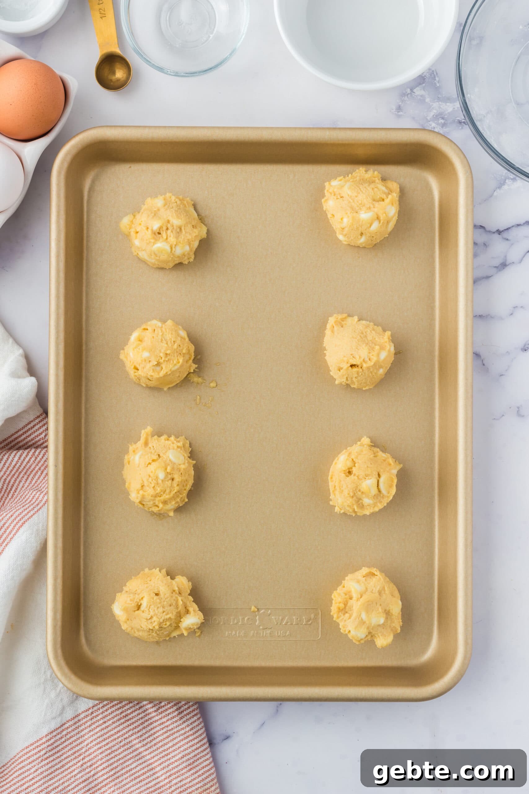 picture of cookie dough balls on a baking sheet