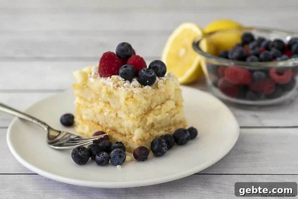Limoncello Tiramisu Recipe: Bright Citrus Italian Dessert 2 A slice of lemoncello tiramisu garnished with raspberries and blueberries