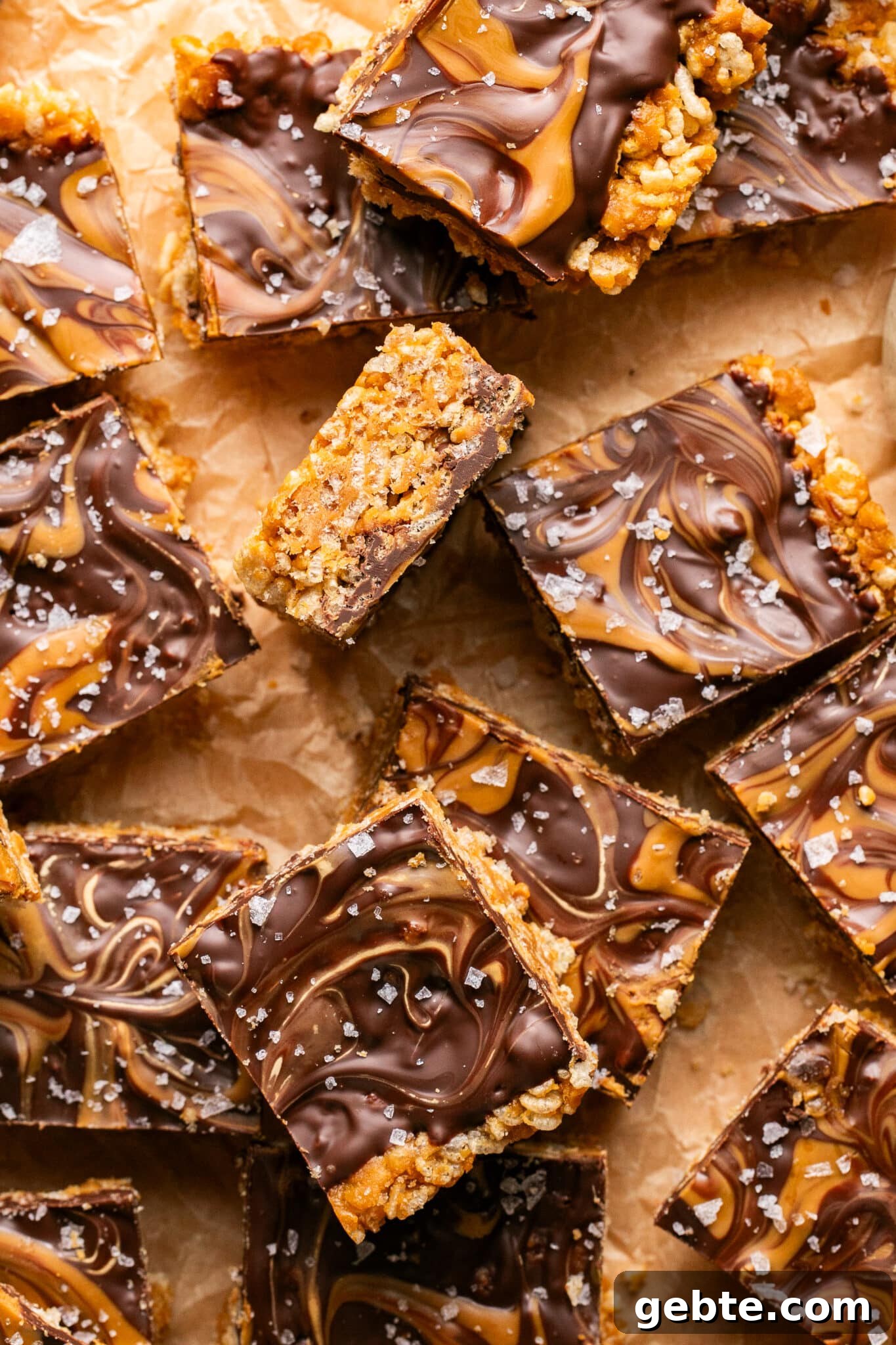biscoff scotcheroos on parchment paper cut into squares.