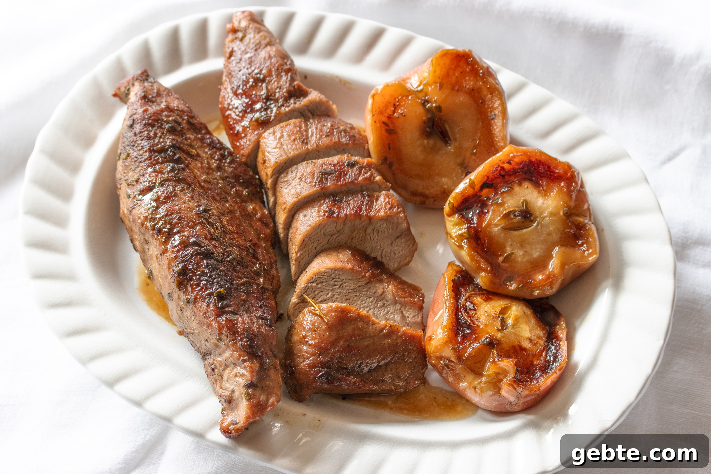 Roasted Pork Tenderloin with Caramelized Apples and Sage 10 The finished recipe on a white platter.