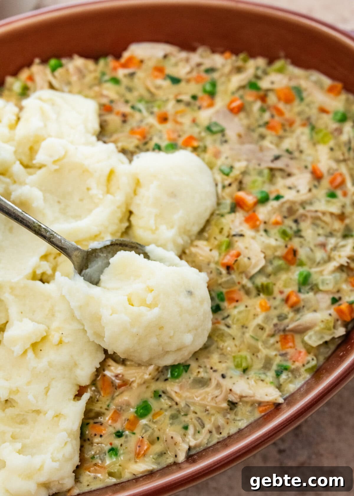 Hearty Turkey Shepherd's Pie Recipe for Comforting Weeknight Dinners 11 add mashed potatoes to the top of the casserole with turkey filling.