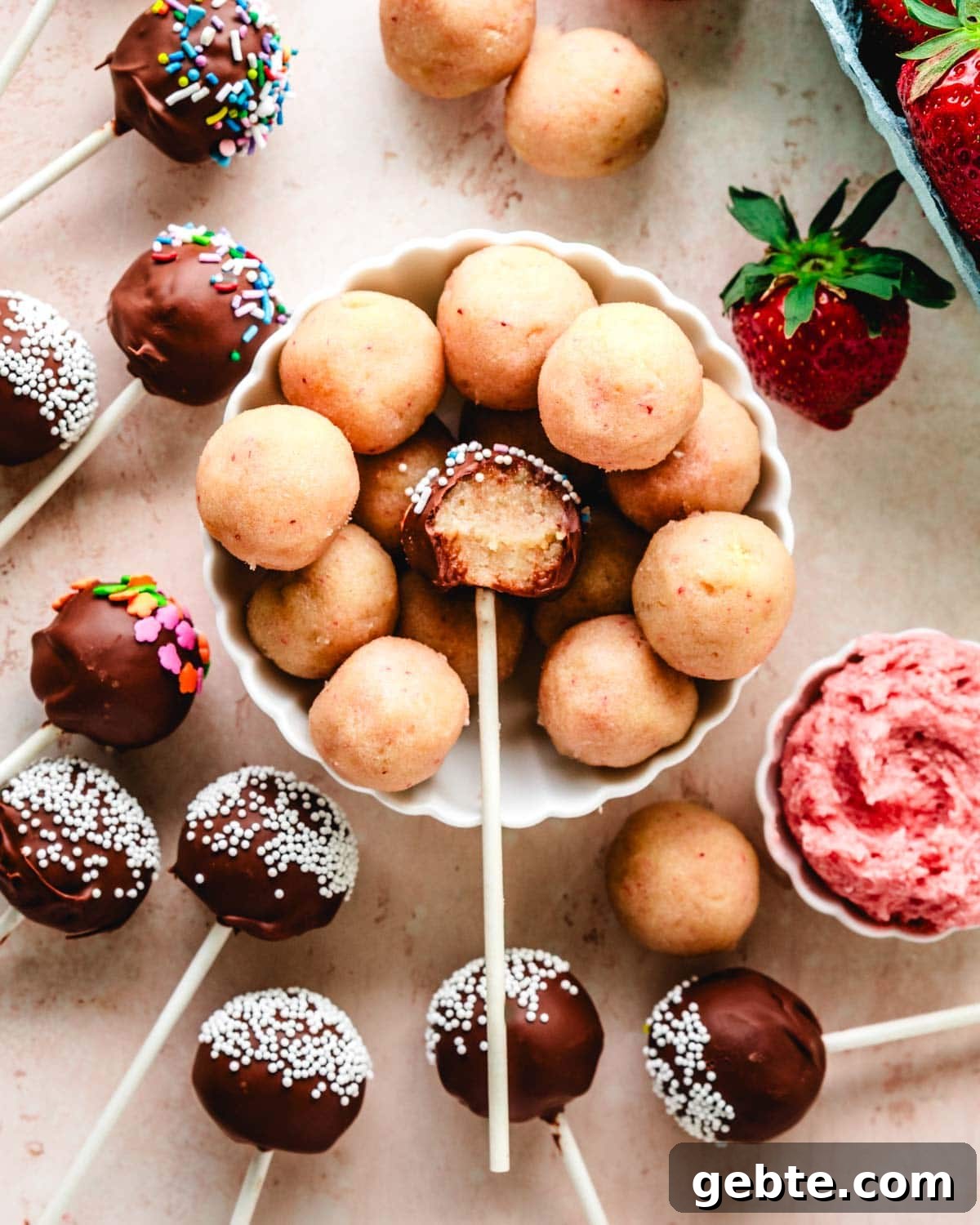 Strawberry Vanilla Cake Pops Recipe for Perfect Party Treats 2 Vanilla strawberry cake pop with a bite taken out.