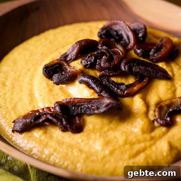 Curried Roasted Cauliflower Soup with Crispy Fried Mushrooms Recipe 4 A bowl of Curried Roasted Cauliflower Soup with Crispy Fried Mushrooms sprinkled over the top.