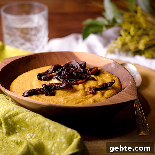 Curried Roasted Cauliflower Soup with Crispy Fried Mushrooms Recipe 9 A bowl of Curried Roasted Cauliflower Soup with Crispy Fried Mushrooms sprinkled over the top.