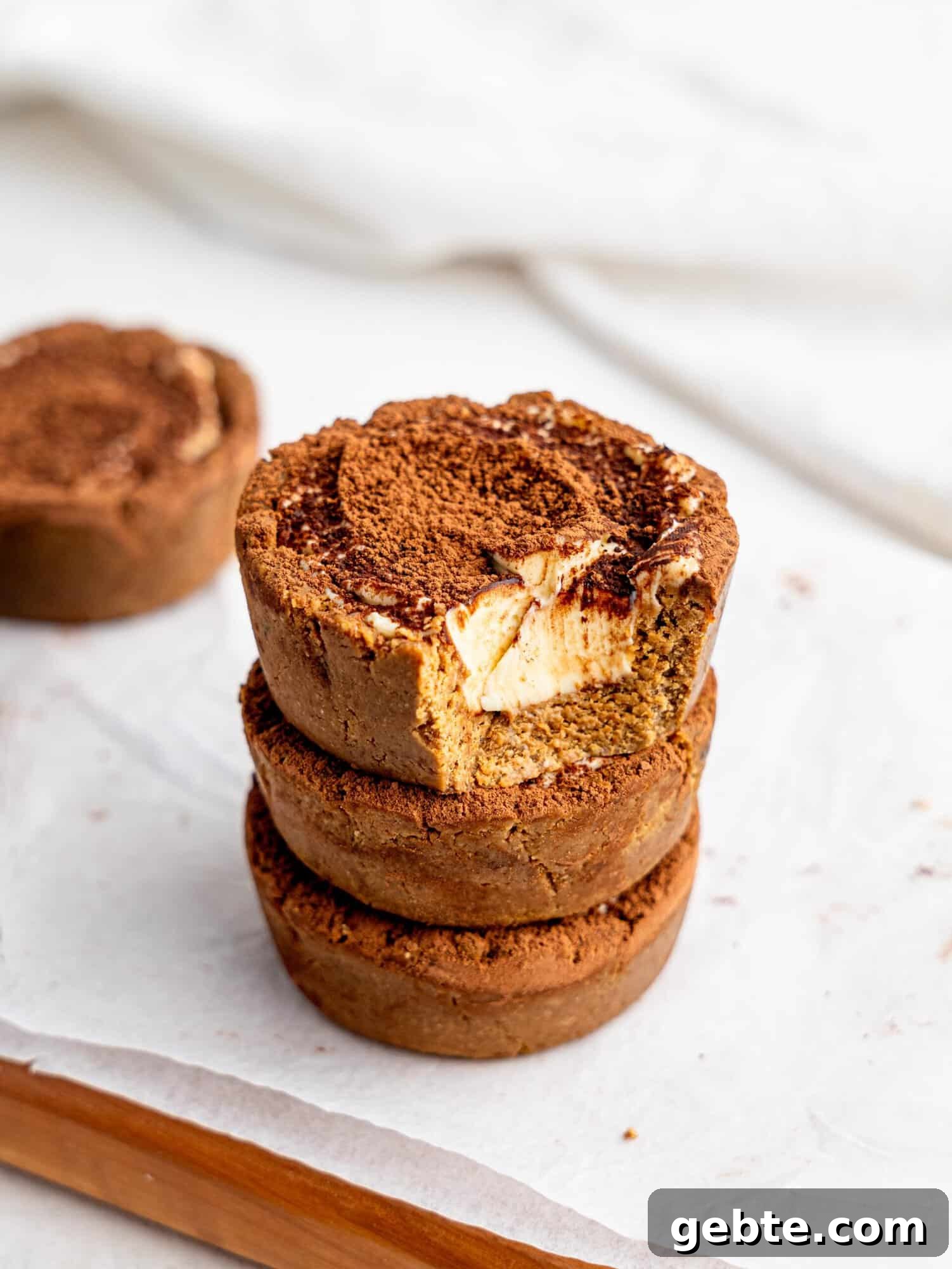 Three Tiramisu cookie dough cups stacked on top of each other.