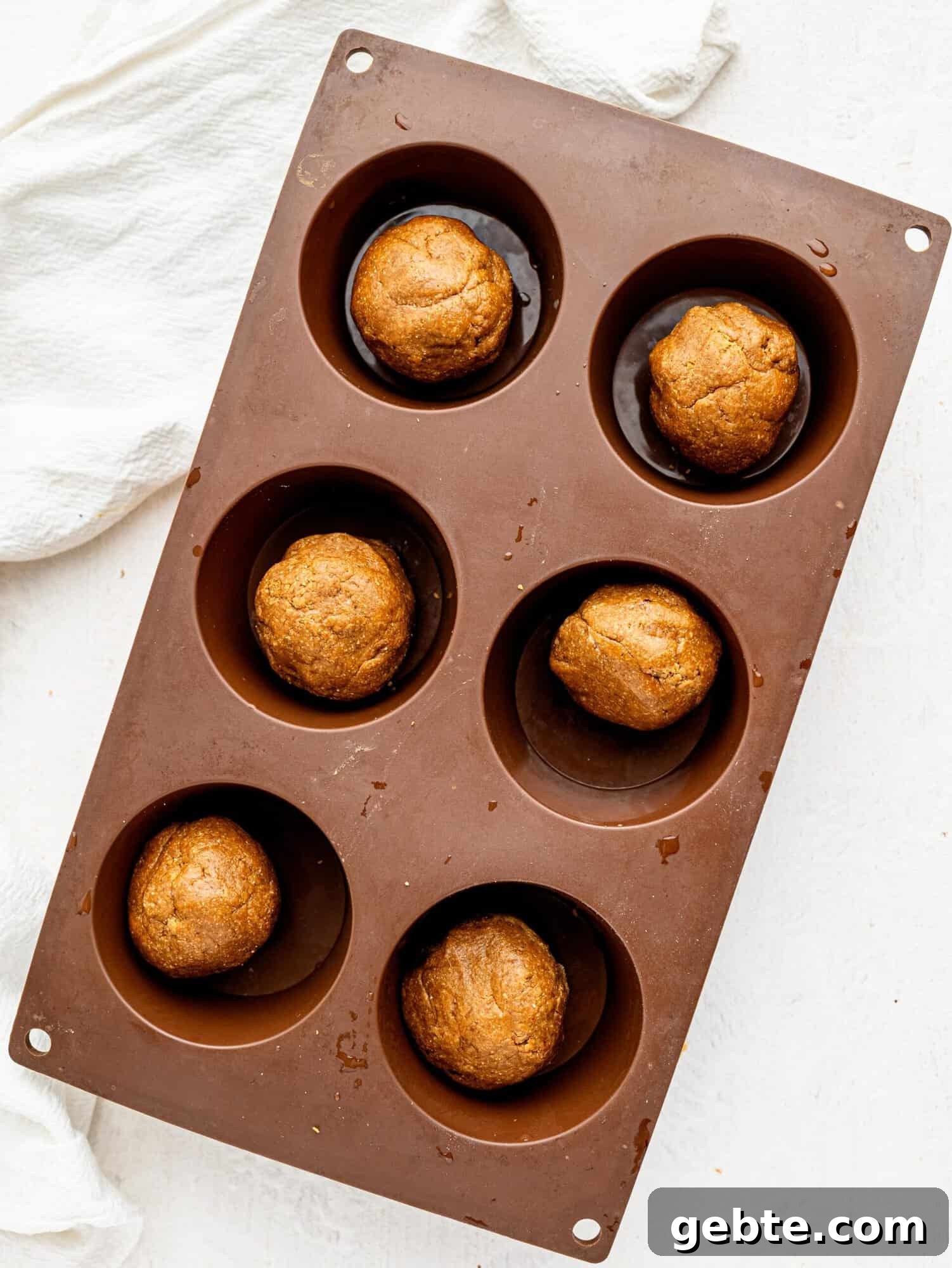 Coffee cookie dough balls in a muffin tray.