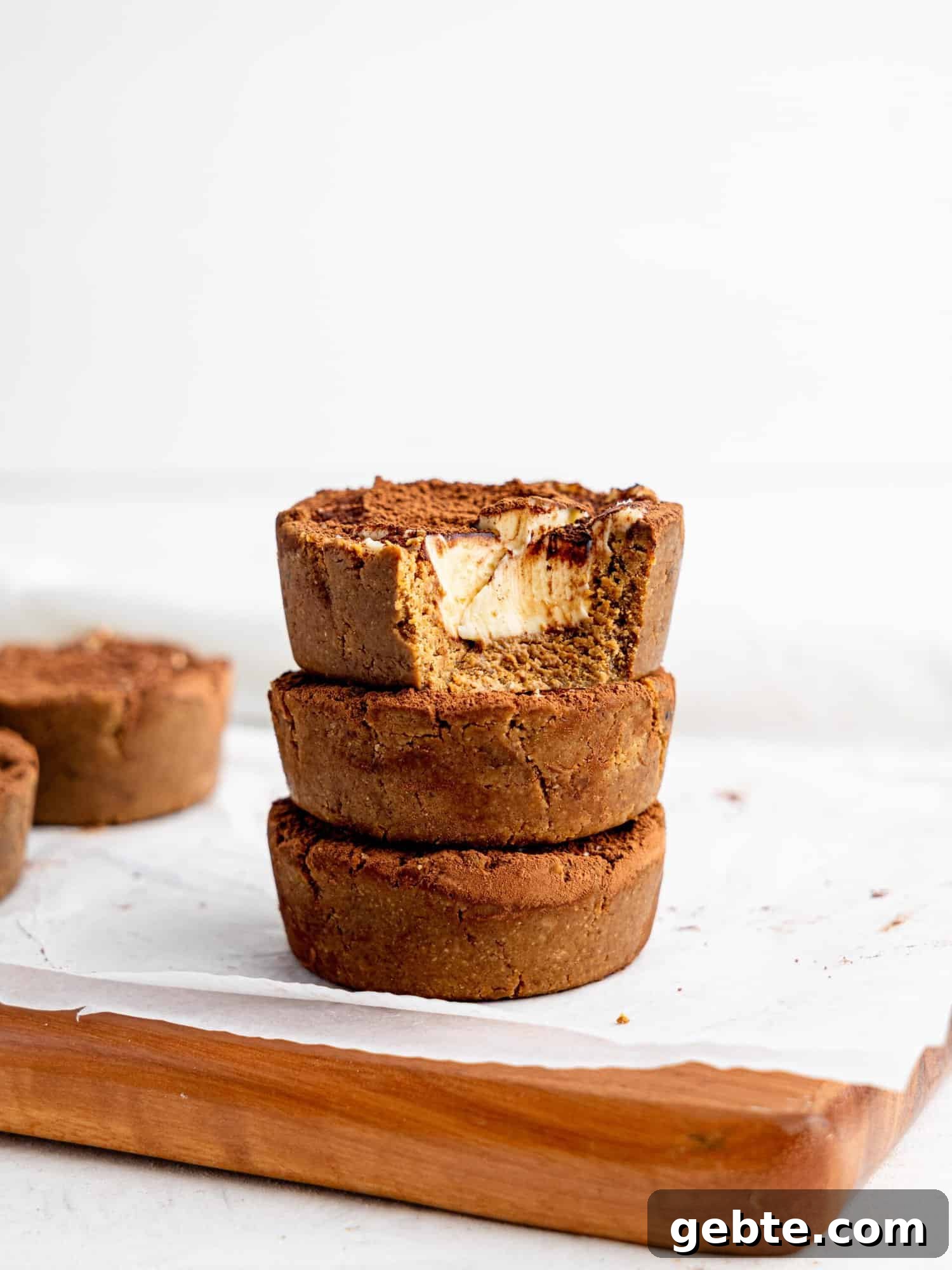 Three Tiramisu cookie dough cups stacked on top of each other.