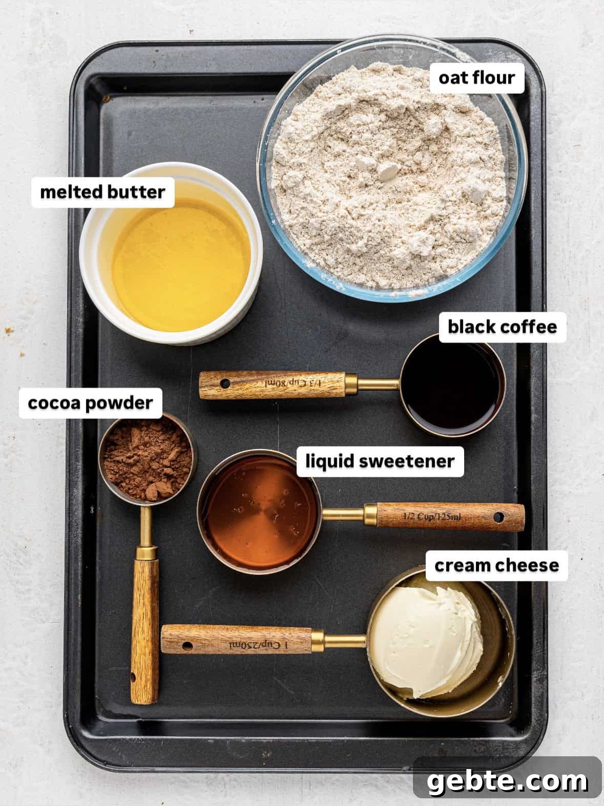 Tiramisu cookie dough cups ingredients on a baking tray.