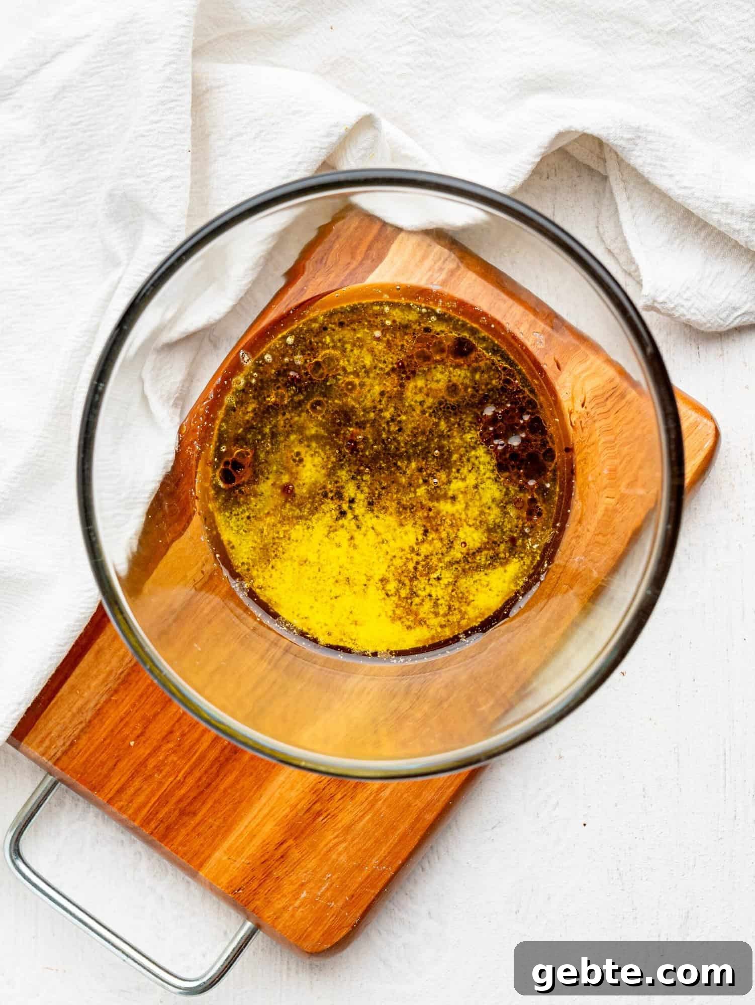 Melted butter, coffee and honey in a glass bowl.