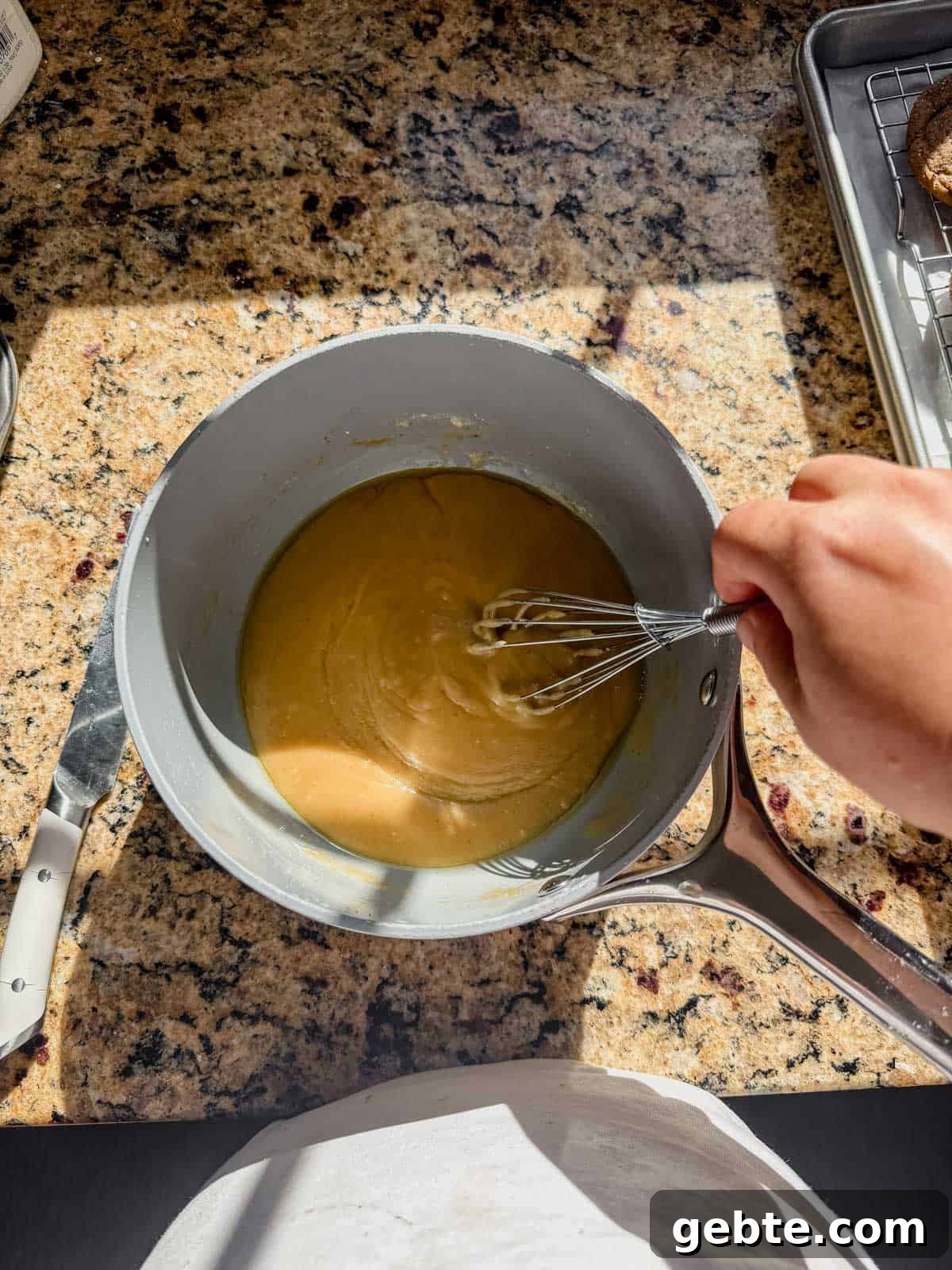 Gingerbread Latte Cookies Recipe — Cozy Spiced Coffee Cookies 9 whisking a brown butter glaze in a saucepan.