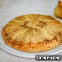 Pear upside-down cake on a plate.