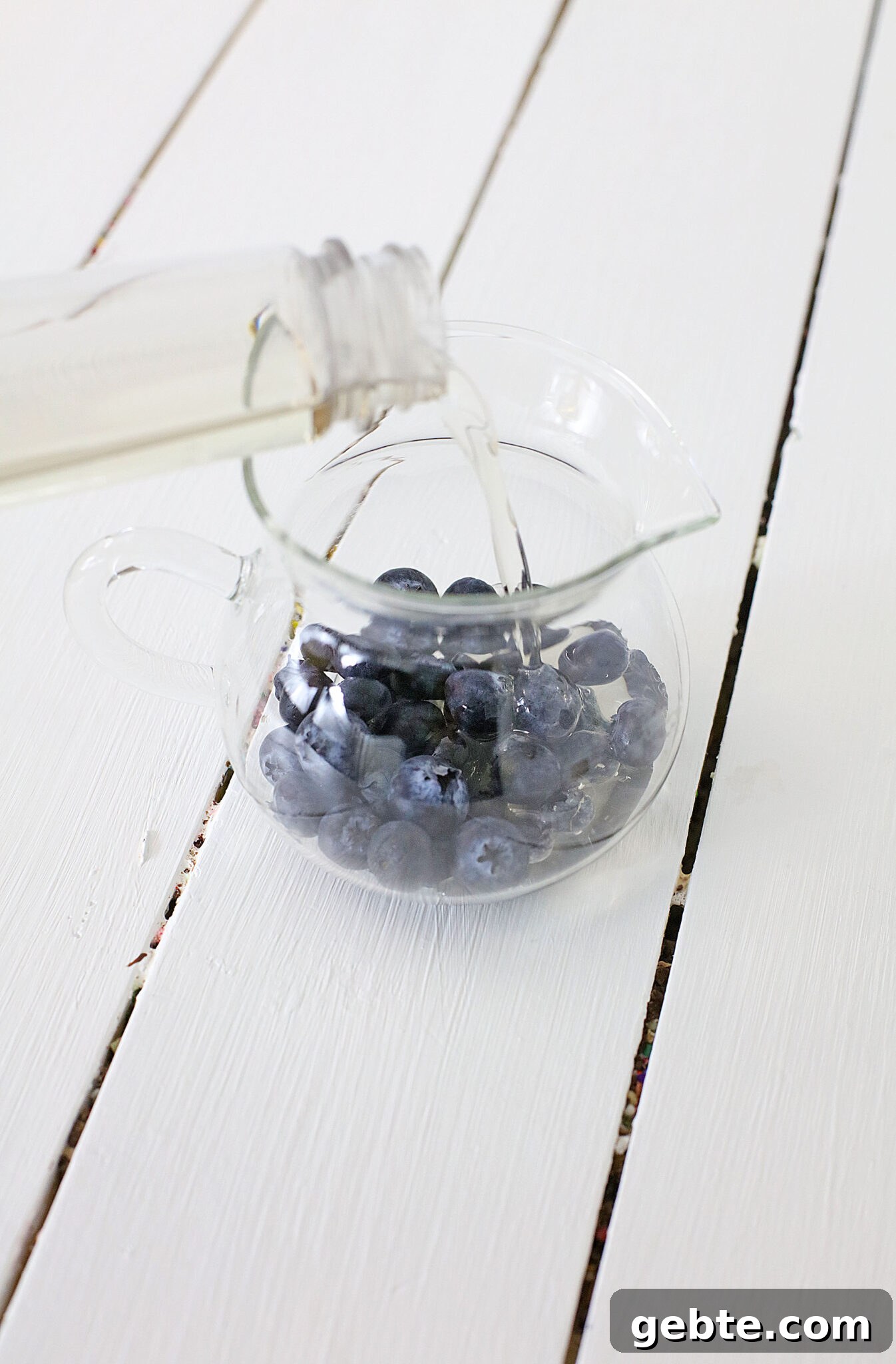 Blueberry Vodka Lemonade Recipe: Refreshing Summer Cocktail 6 Blueberries in a pitcher