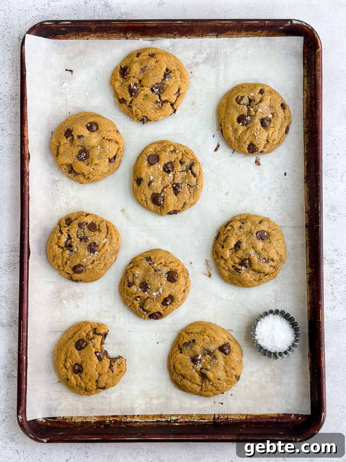 Chewy Pumpkin Chocolate Chip Cookie Recipe for Fall Baking 11 all the chewy pumpkin chocolate chip cookies scattered on a baking sheet.