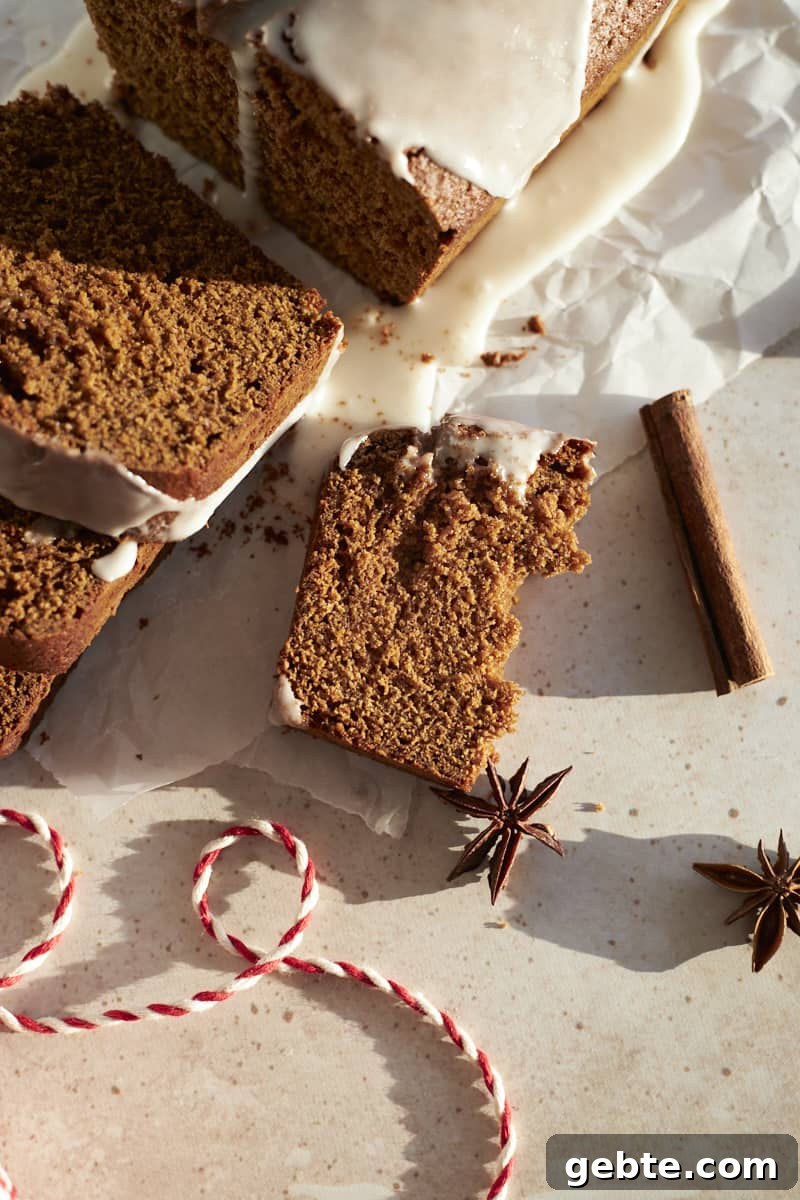 A piece Sourdough Discard Gingerbread Loaf broken in half.