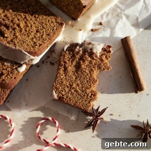 A piece Sourdough Discard Gingerbread Loaf broken in half.
