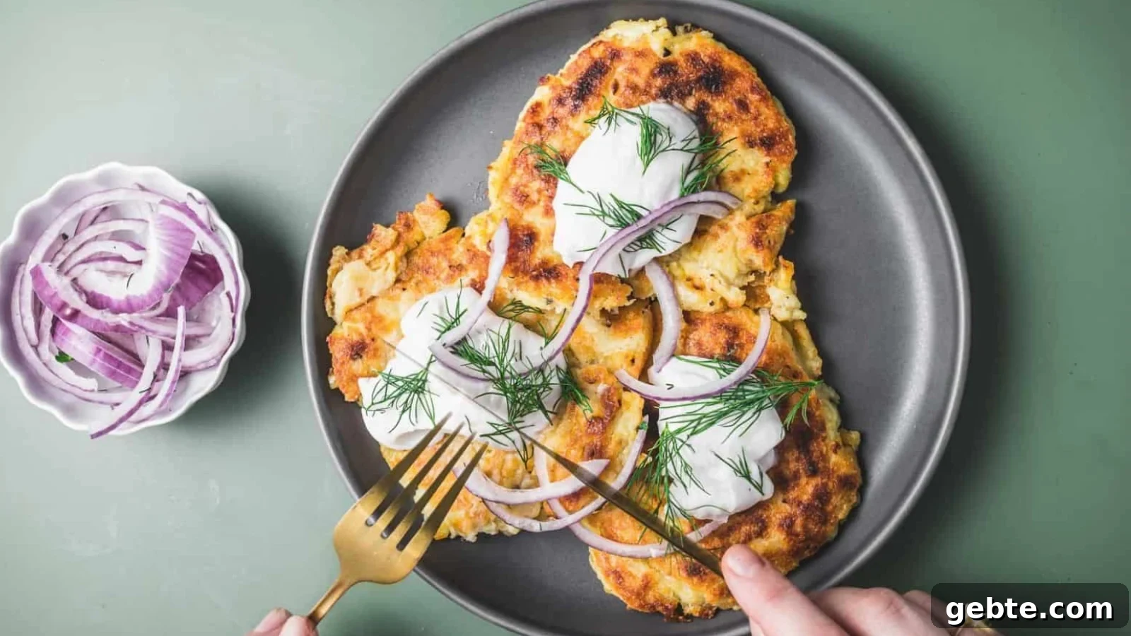 Irish boxy potato pancakes on a plate, and sliced onions in a small bowl beside them.
