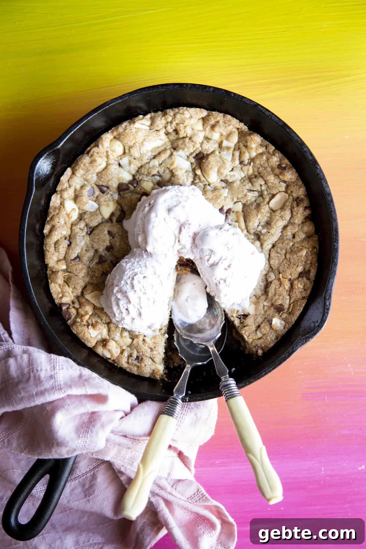 Overhead view of a pizookie in a skillet with ice cream on top
