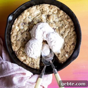 Overhead view of a pizookie in a skillet with ice cream on top